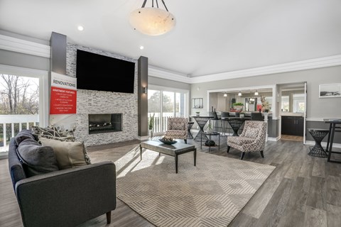 a living room with a fireplace and a tv